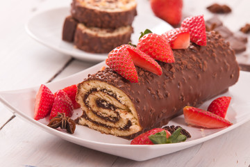 Chocolate roll with strawberries. 