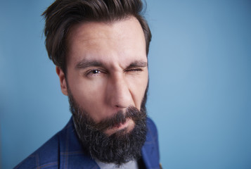 Shot of man with beard winking