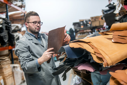 business manager at leather shoe factory doing various daily tasks