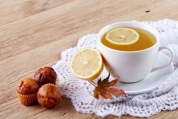 white cup of tea with cookies on a wooden background white cup of tea with cookies on a wooden background. copy space.