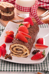 Chocolate roll with strawberries. 