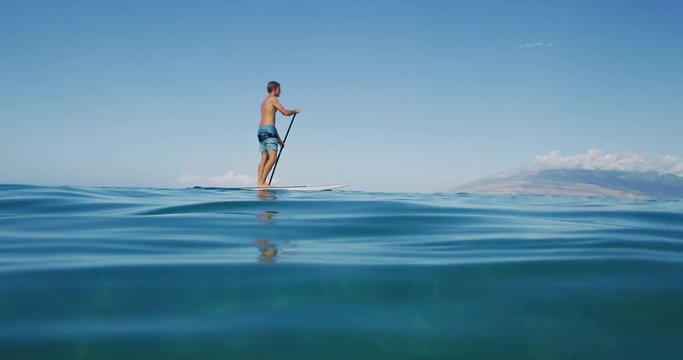 Family stand up paddle boarding in the ocean