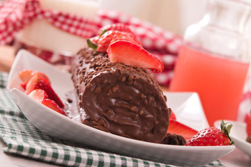 Chocolate roll with strawberries. 