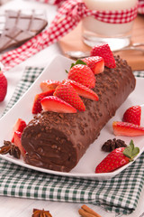 Chocolate roll with strawberries. 