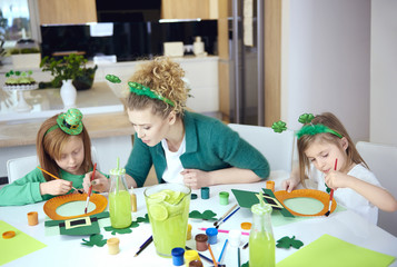 Children with mother doing decorations