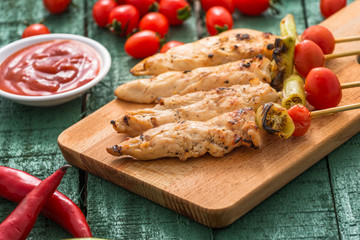 Chicken kebab with vegetables on wood

