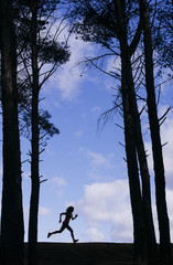 silhouette of two beautiful women running through the forest.