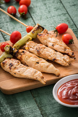 Chicken kebab with vegetables on wood


