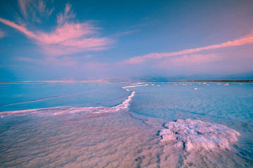 Early morning, sunrise over Dead Sea. Salty textured sea shore. Israel