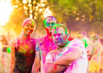 Guys with a girl celebrate holi festival