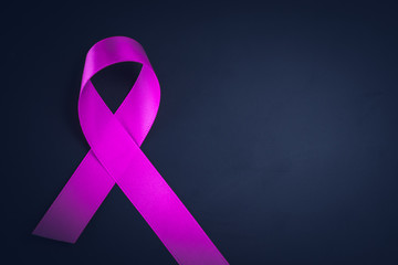 Purple ribbon awareness on black background  for World Cancer day.