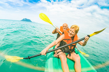 Senior happy couple taking travel selfie on kayak at Ang Thong marine park in Ko Samui - Trip to...