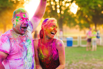 Guys with a girl celebrate holi festival