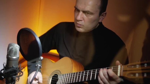 Guitarist plays classic music songs by acoustic guitar at sound studio