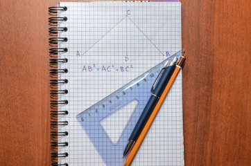 Page with formulas and the Pythagorean theorem with pen, pencil and ruler