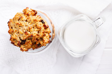 Healthy oatmeal cookies with raisins on white table.
