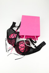 sexy pink lingerie bra with a present bag. Lingerie shopping for underwear - shopping concept