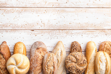 Delicious fresh bread on wooden background