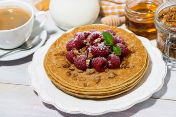 traditional pancakes with fresh raspberries for breakfast on wooden table, top view