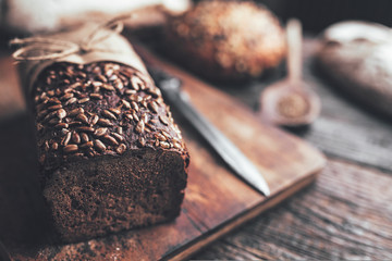 Delicious fresh bread on wooden background