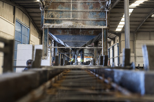 Concrete deposit filling iron mold structure to create construction concrete pieces