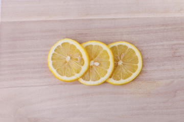 Top view of sliced lemon on wooden background.
