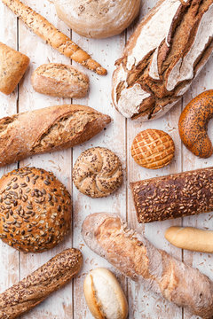 Delicious fresh bread on wooden background