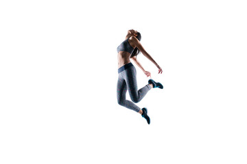 Fototapeta na wymiar Deep breath after hard training! Concept of purity freedom. Side profile full-length portrait of fitness slender sporty woman is jumping up against white background, wearing sport outfit ans shoes