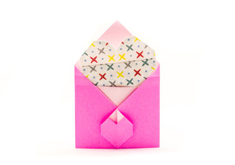 pink origami envelope with white paper heart isolated on white