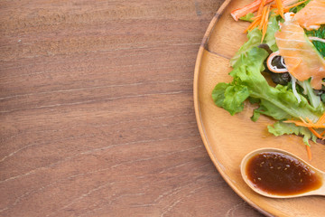 Diet food, fresh vegetable salad with salmon and dressing in Japanese style,on white background.