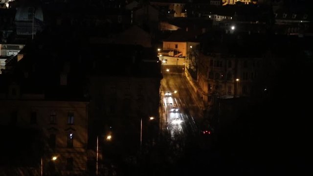 Cars drive through the night city