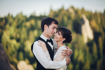 Luxury wedding couple is hugging each other in mountains