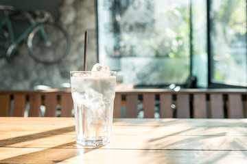 drinking water in clear glass standing on wood table