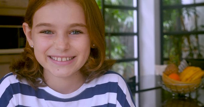 Adorable 10 year old girl smiling and looking at the camera