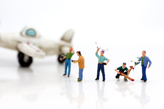 Miniature people: Group people playing and operating plane with remote control . Image use for background technology, business concept.