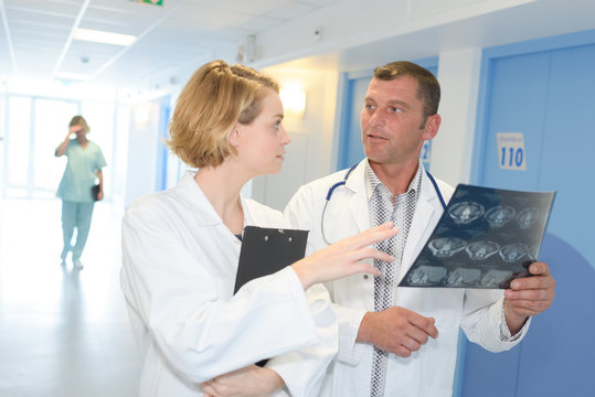 male and female doctor looking at patient xray
