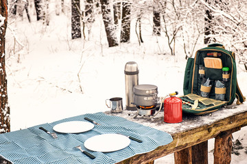 Preparing the meal in the winter hike at the table in the campsite.