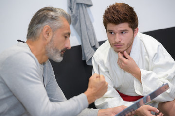 karate coach and student talking