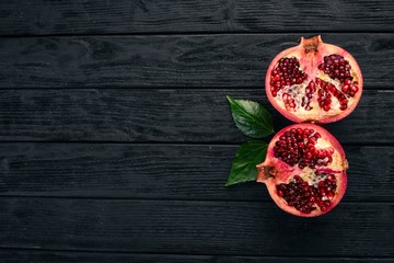 Pomegranate fruit. Tropical Fruits. On a wooden background. Top view. Copy space.