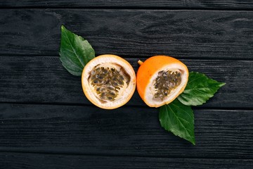 Granadilla Tropical Exotic Fruits. On a wooden background. Top view. Copy space.