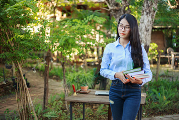 portrait woman with a book in garden