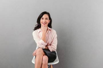 Portrait of a smiling businesswoman sitting in a chair