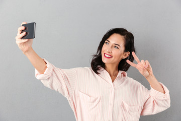 Portrait of a happy businesswoman taking a selfie