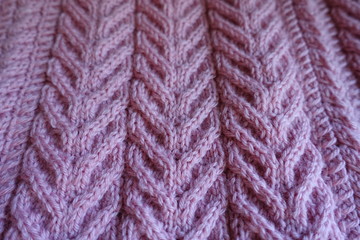 Closeup of pink knitted fabric with pleats pattern