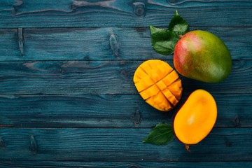 Mango. Tropical Fruits. On a wooden background. Top view. Copy space.