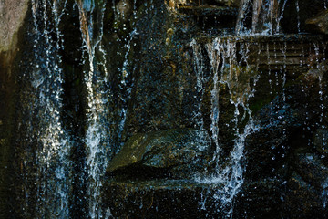 Close up of water splashing on rocks from a waterfall Water on decorative stones