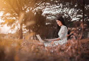 Fototapeta na wymiar beautiful woman using laptop in the park
