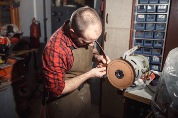 Working process in the leather workshop. Tanner in old tannery.