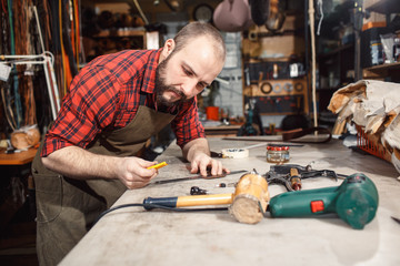 Working process in the leather workshop. Tanner in old tannery.