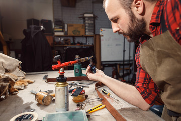 Working process in the leather workshop. Tanner in old tannery.
